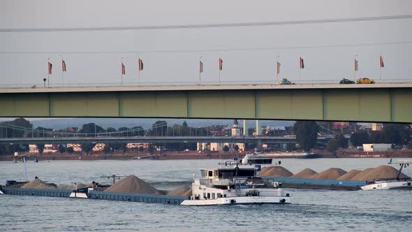 Cologne with Zoo Brücke with cargo ship on river Rhine