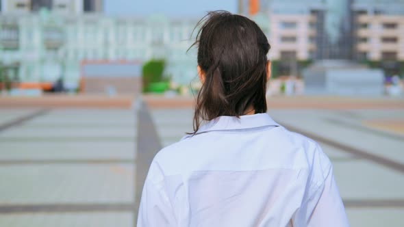 Rear Close Up Woman Walks Outdoors Urban City Background