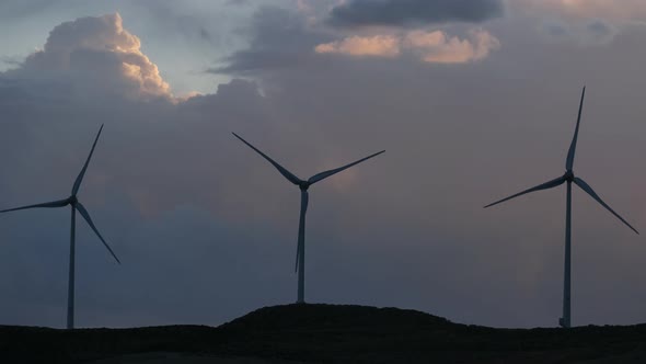 group of windmills for renewable electric energy production. Production of green energy with wind