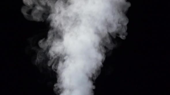 Smoke Billowing Over Steady Flow on Isolated Black Studio Background