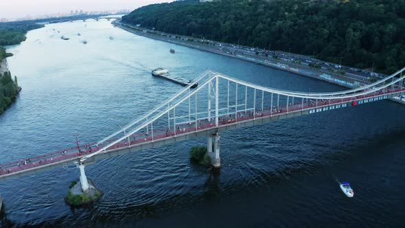 View of Pedestrian Bridge with People Walking Across the Dnipo River in Kiev