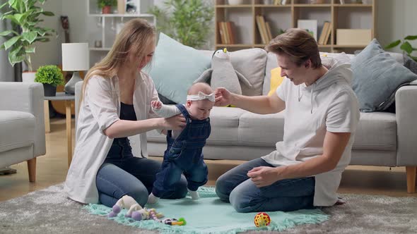 Mom and Dad Teach to Walk a Little Daughter