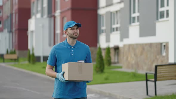 Blue Delivery Man Send a Package to Customer on Before Deliver Cargo