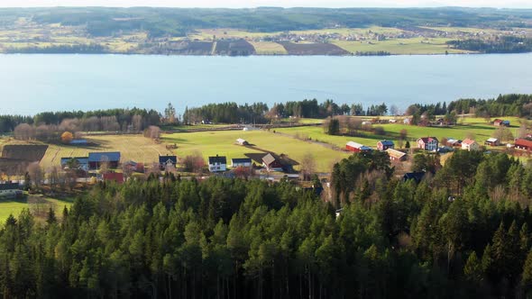 Farm Houses And Buildings Near Lake In Swedish Countryside Near Ostersund, Sweden. 4K Drone.