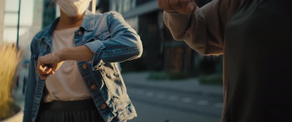 Close up video of women greeting contactless on the street. Shot with RED helium camera in 8K.