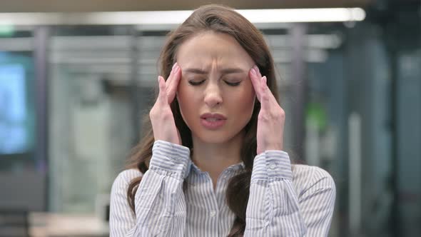 Portrait of Young Businesswoman having Headache