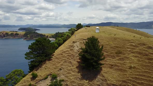 Girl Walking Down Steep Hill in New Zealand