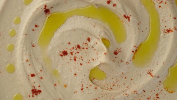 hummus with smoked paprika and olive oil top view close up