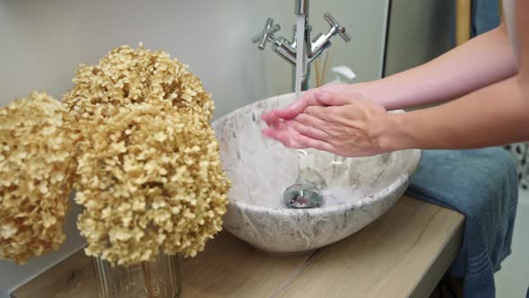 Woman Wash Her Hands with Soap in Bathroom