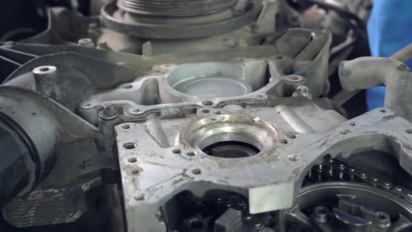 View of disassembled car engine. hands of mechanic repairing engine