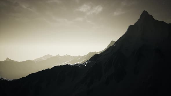 Mountains in Evening Cloudy Sky alt