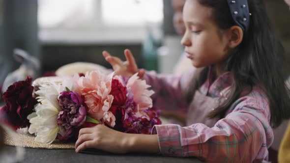 Kids Decorating Straw Hats with Flowers before Easter