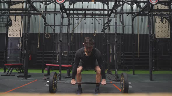 Caucasian Strong Athletic Man Having Workout and Bodybuilding with Barbells Weight