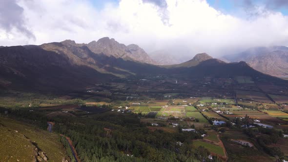 Scenic road of Franschhoek pass overlooking lush wine valley and farms