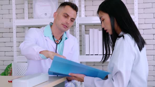 Doctor in Professional Uniform Examining Patient at Hospital