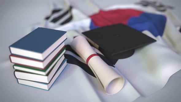 Graduation Cap and Diploma on the Flag of South Korea alt