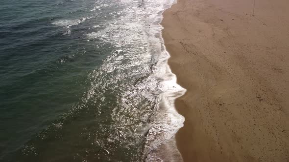 Aerial View of Rocky Beach and Sea Waves