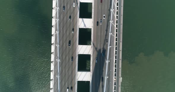 Aerial shot of vehicles moving on San Francisco–Oakland Bay Bridge with city in background