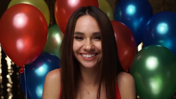 Birthday Party. Smiling Woman Blowing Glitter Near Balloons