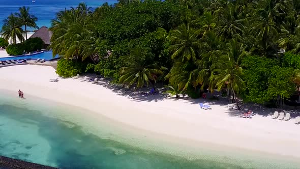 Aerial drone scenery of marine shore beach by blue lagoon with sand background