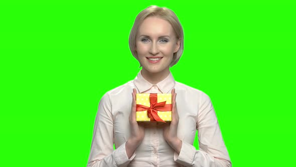 Portrait of Mature Woman with Yellow Gift Box with Ribbon