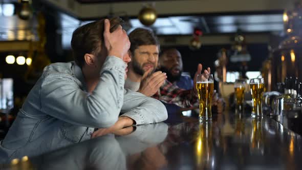 Unhappy Male Fans Watching Sport Game in Pub, Disappointed With Losing Match