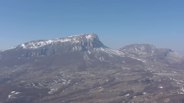 Winter scenery with mountain Stol under clear blue sky 4K drone footage