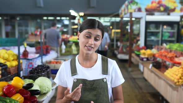 Woman Seller at the Counter with Vegetables