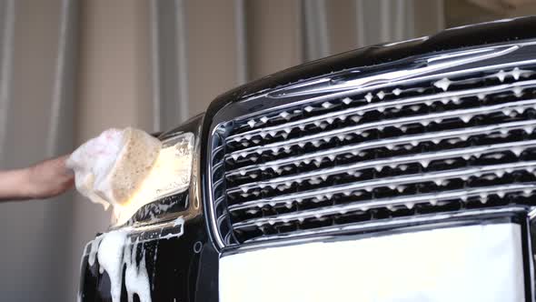 Man Washing His Car in a Garage