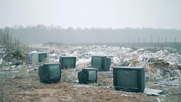 Snowfall at the Rubbish Dump Woth Broken TVs