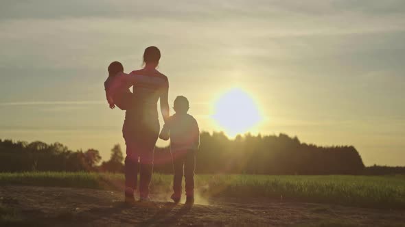Happy Family Together in Nature at Sunset