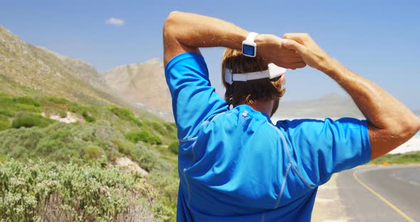 Rear view of triathlete man exercising on a sunny day