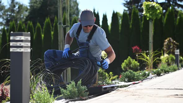 Landscaping Worker Preparing Trickle Irrigation Plastic Pipe