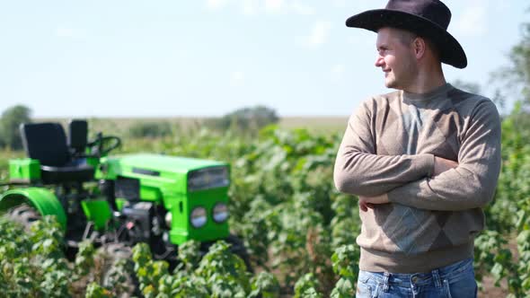 Young Happy Farmer Rejoices at His New Tractor