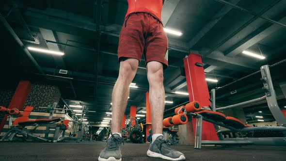 Sportsman Is Doing Pushups with Dumbbells in the Fitness Center