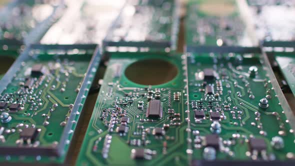 Slider Shot of a Connectors Component and Large Green Microcircuit in Workshop Laboratory