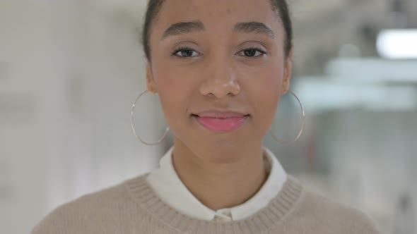 Close Up of Face of Young African Girl Smiling at the Camera