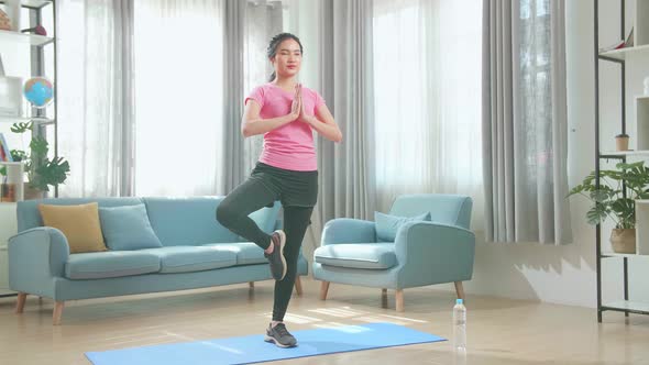 Young Asian Woman Doing Yoga At Home