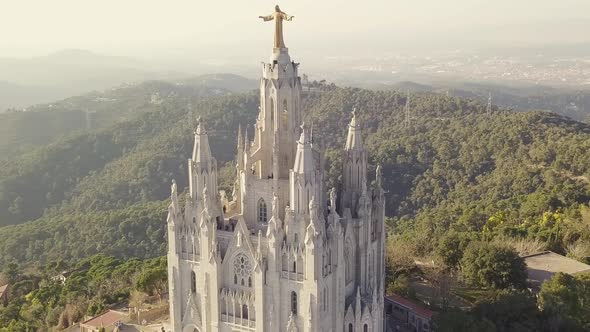 Tibidabo Church With Jesus Statue In Barcelona. Aerial shot at sunset.