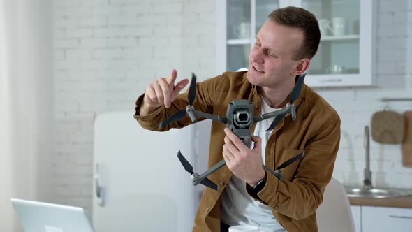 Young man holding drone for shooting video