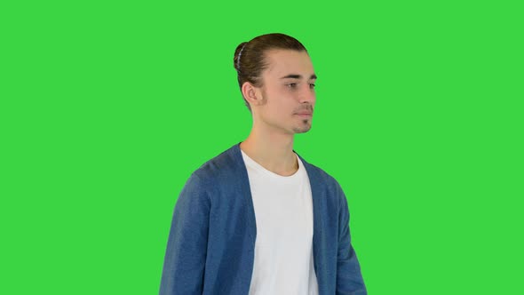 Young White Man Walks Slowly on a Green Screen Chroma Key