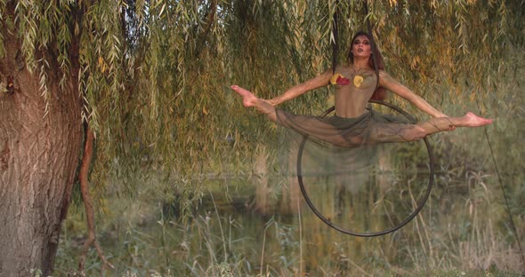 Amazing Gymnastics Woman is Doing a Split on a Hoop Spinning Dryad Cosplay