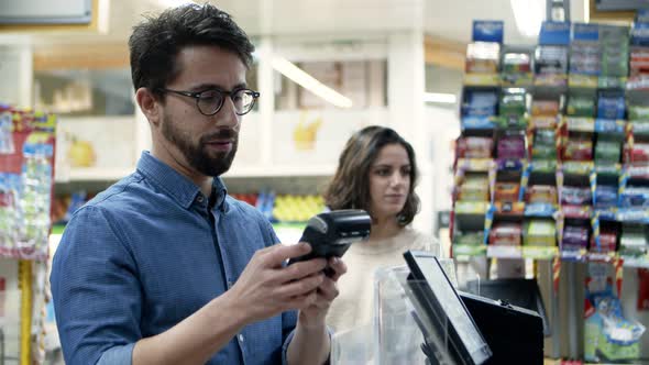 Man Paying with Credit Card in Supermarket