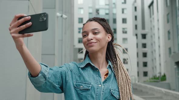 Happy African American Girl Taking Selfie of Urban City Background