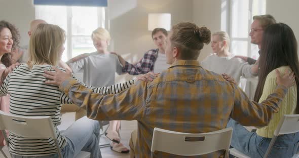 Young People Holding Hands Together During Group Therapy