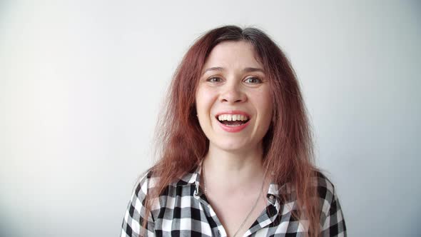 Young Happy Woman Looks in the Mirror and Plucks a Grey Hair From Her Head. Concept Photo of Young