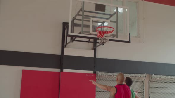 Basketball Players Boxing Out for Rebound in Match