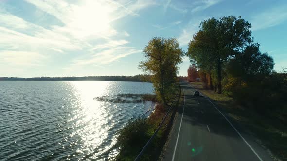 Road in the Autumn Forest By the Lake Side