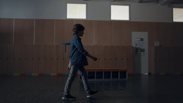 Relaxed Pupil Walking Dark School Hall Alone