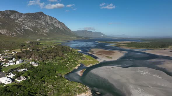 Elevated aerial view over Klein River Lagoon next to scenic mountains, Hermanus